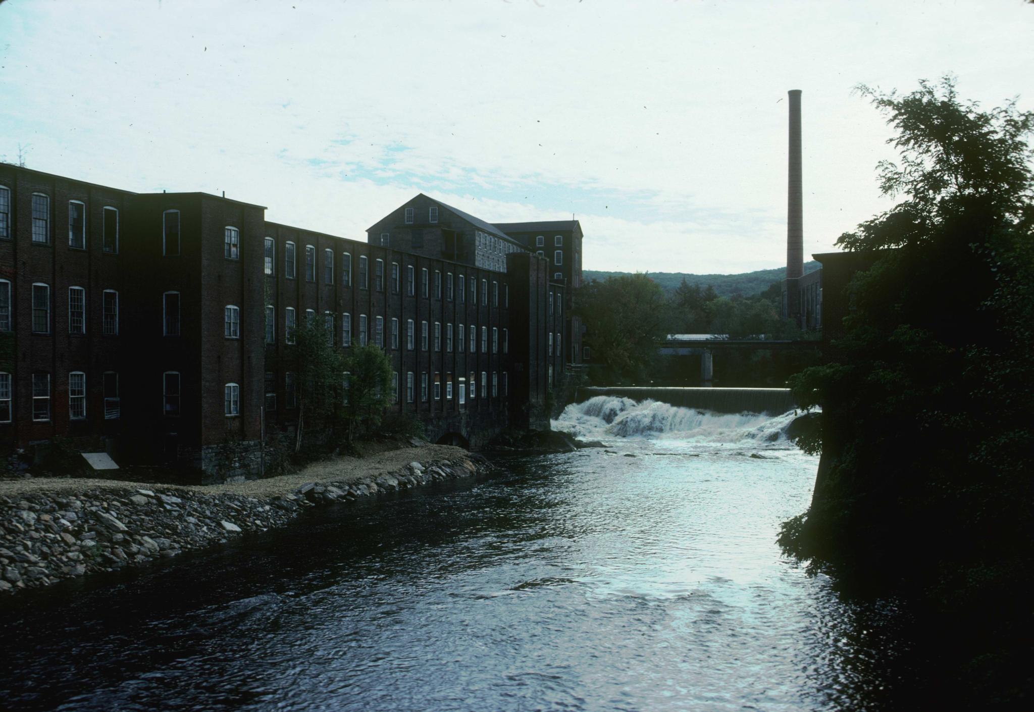 Photograph of mill buildings, river and dam at Ware, Massachusetts.