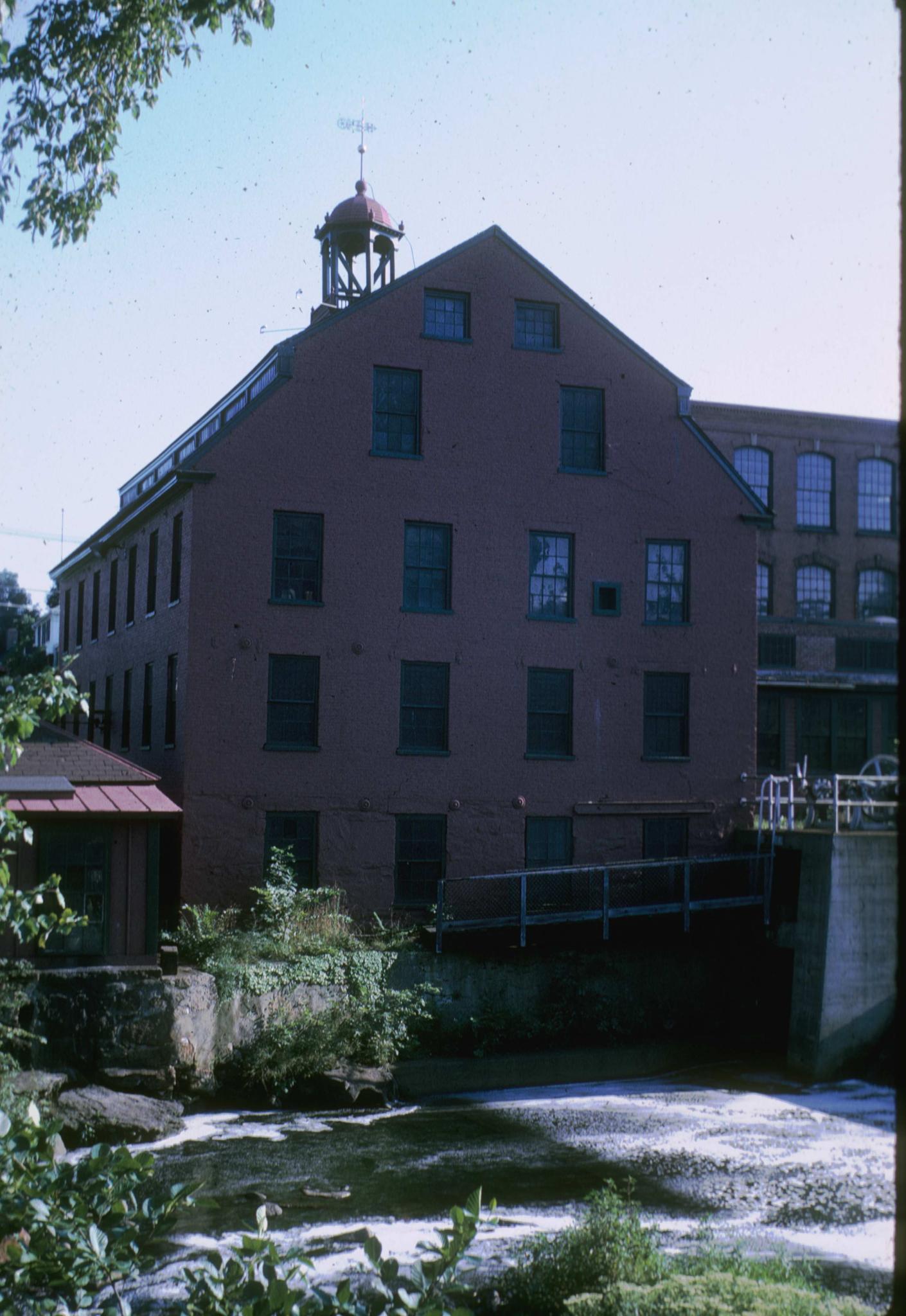 Photograph of the original brick mill in Whitinsville, Massachusetts.  