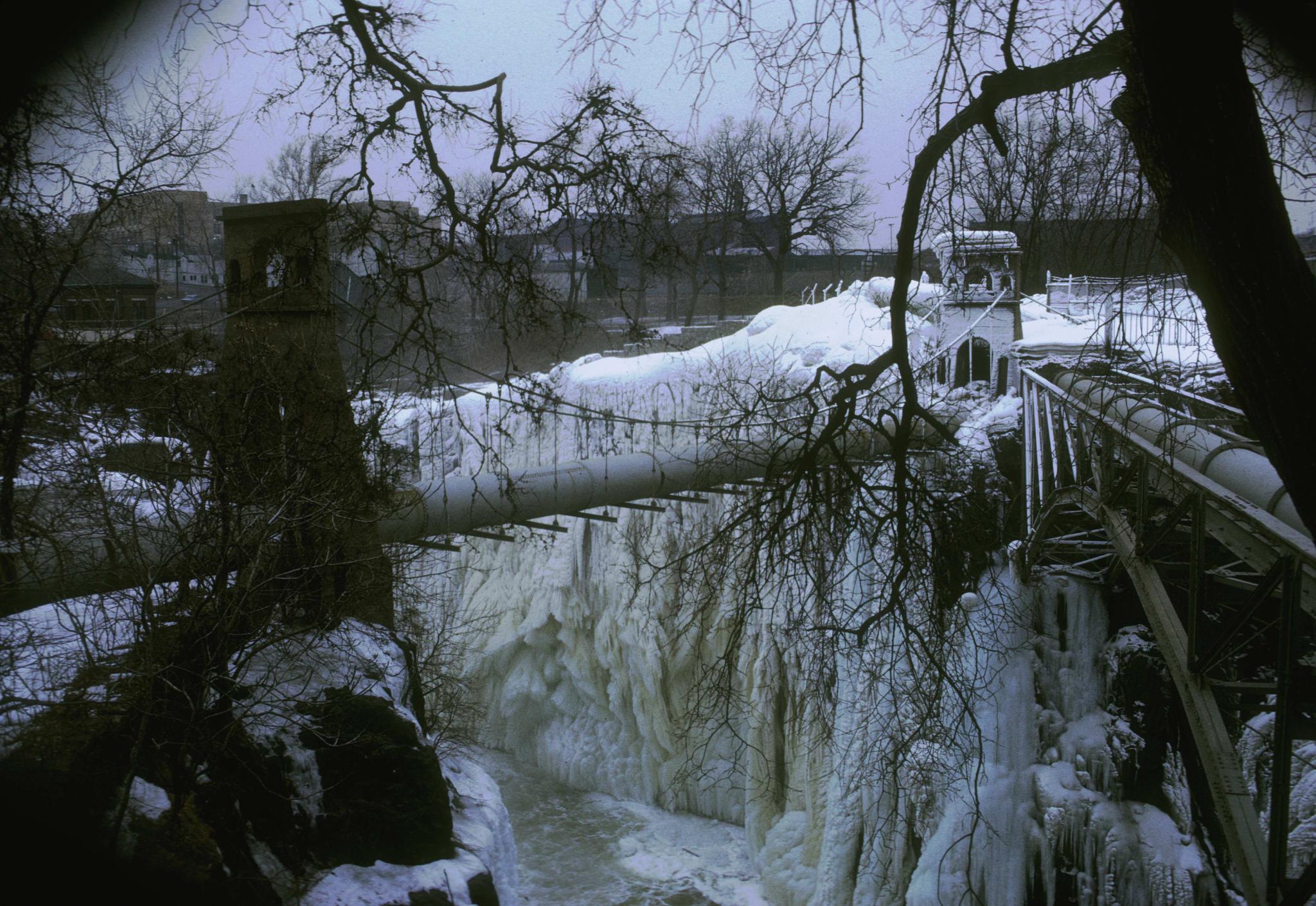 Photograph of an unidentified pipe suspension bridge crossing Passaic Falls at…