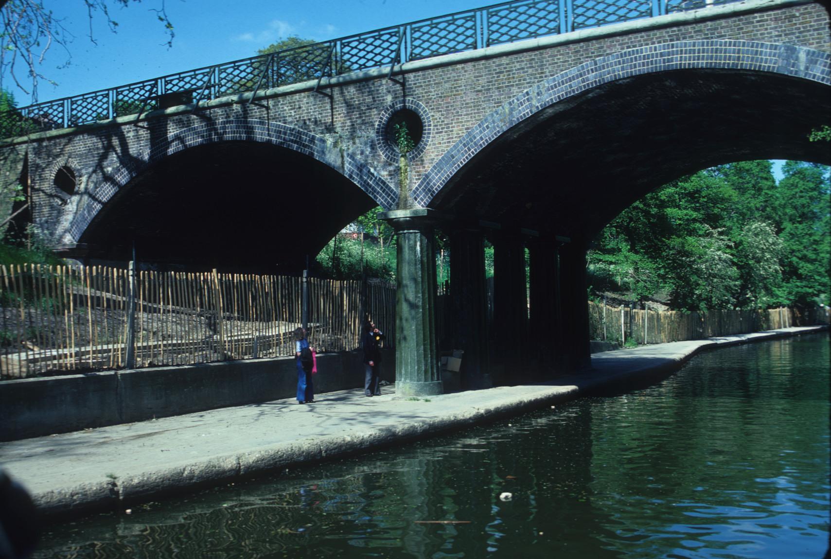 Two brick arches of road bridge over the Regents Canal, London, supported by…