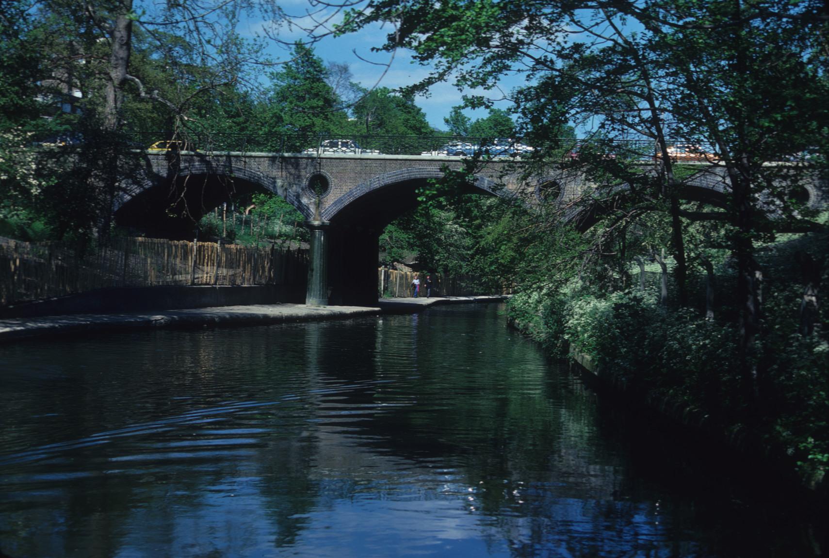 Three arches of road bridge over the Regents Canal, London. Brick structure…