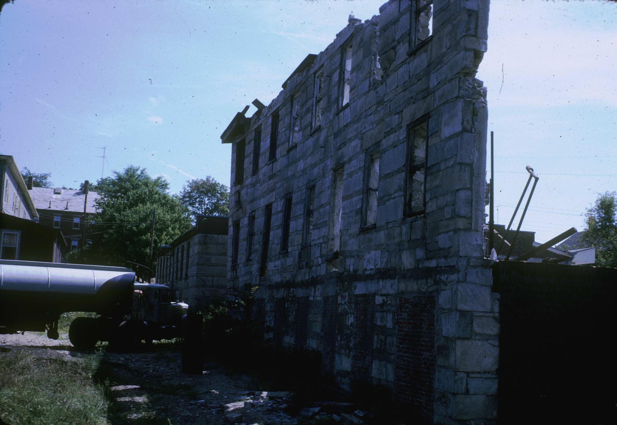 Photograph of the mill ruins looking along a standing wall.