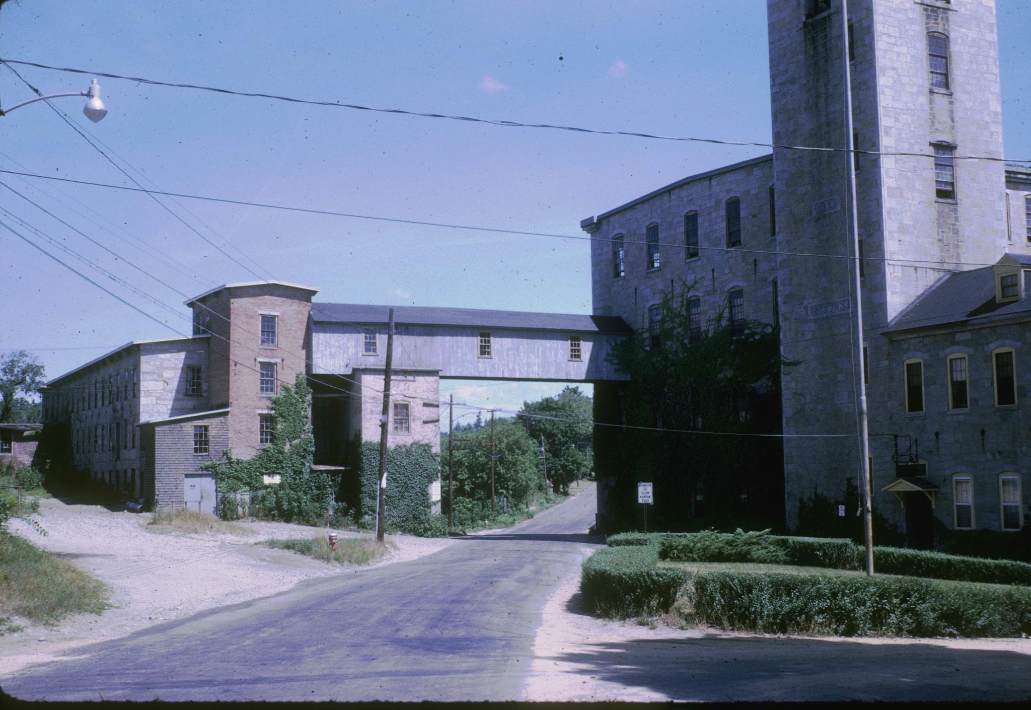 Photograph of the mill looking down a road that bisects the facility.