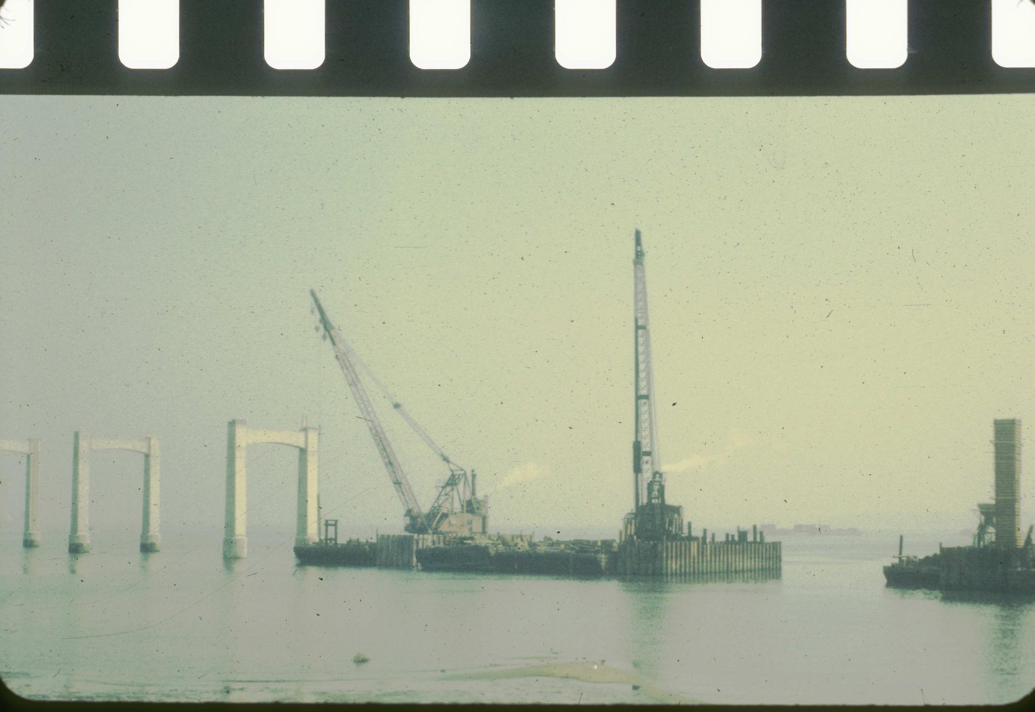 Photograph of the Throg's Neck bridge showing construction of piers with…