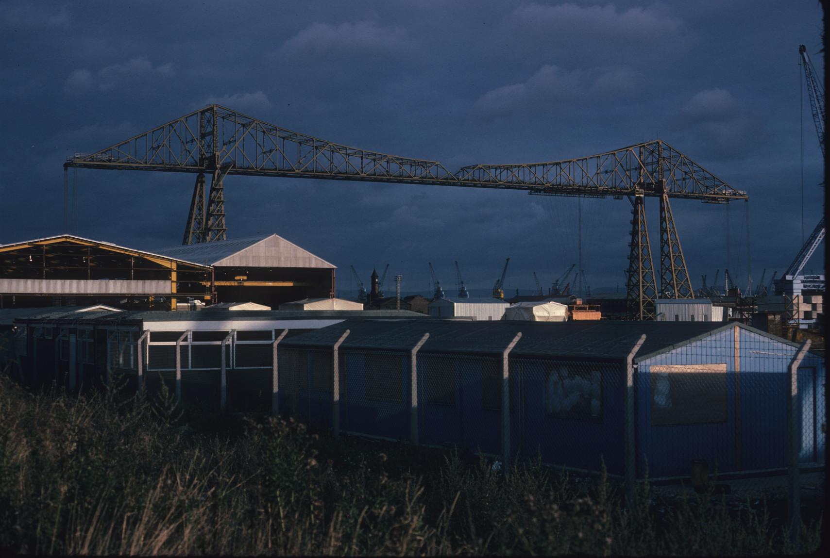 Another view of the Middlesbrough Transporter Bridge at sunset, with cranes…