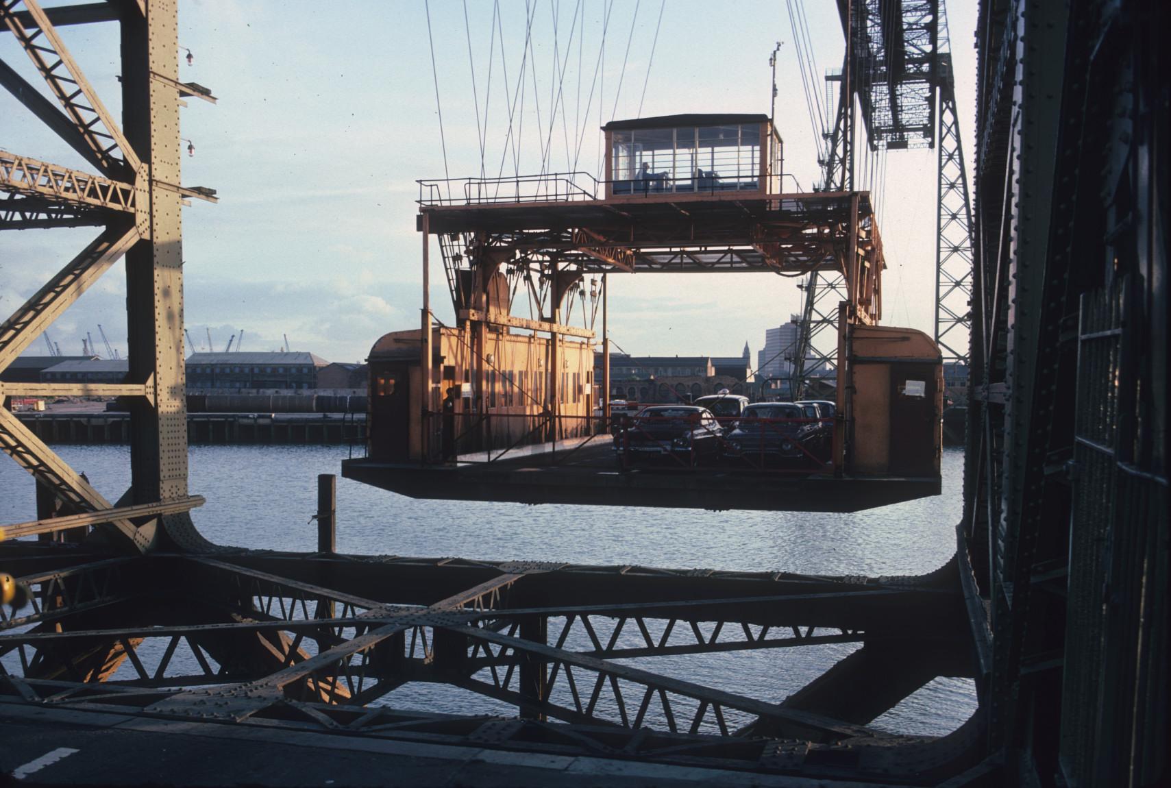 Detail of the gondola loaded with vehicles approaching the landing stage.