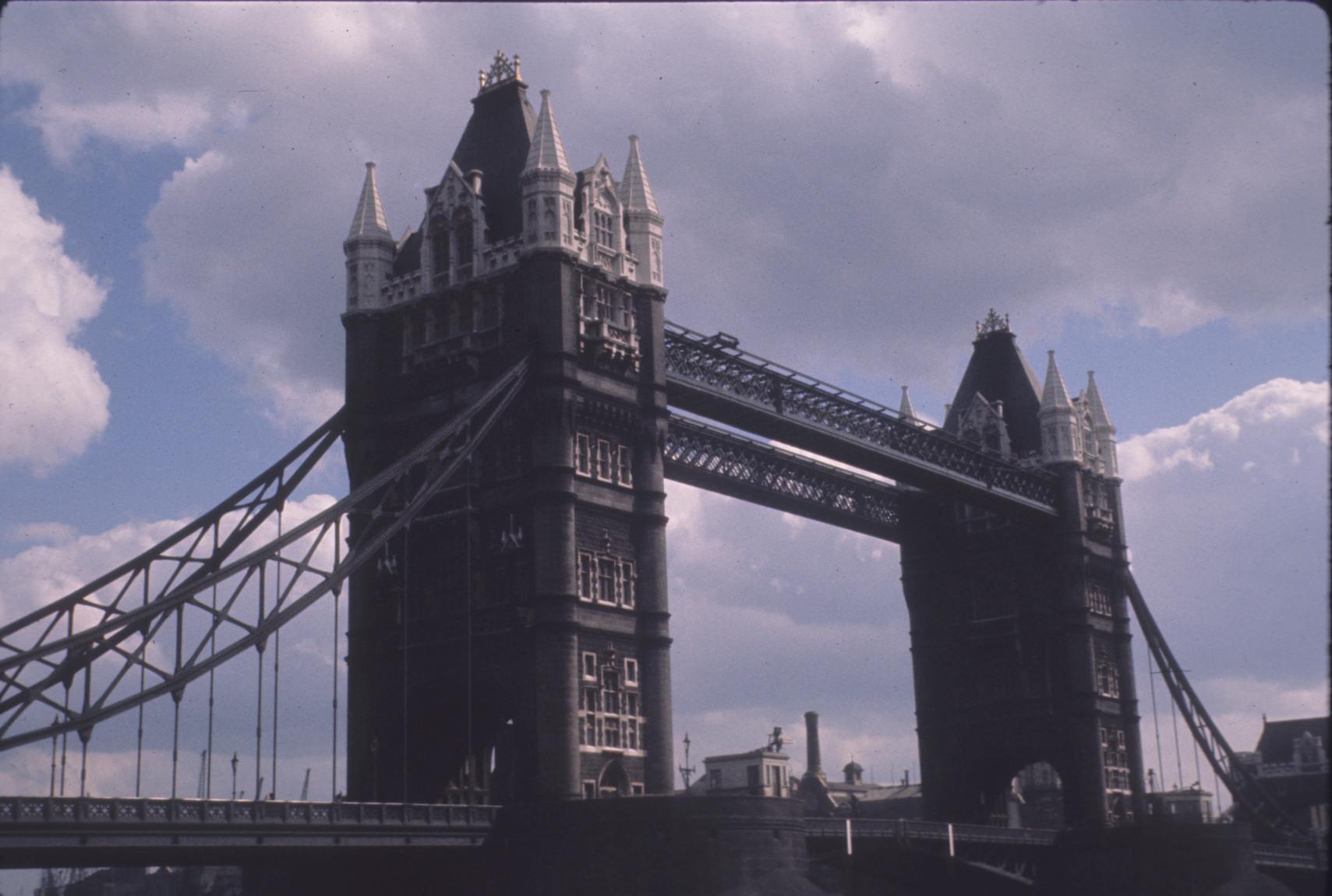 General view of Tower Bridge, focusing on the towers and the pedestrian walkway.