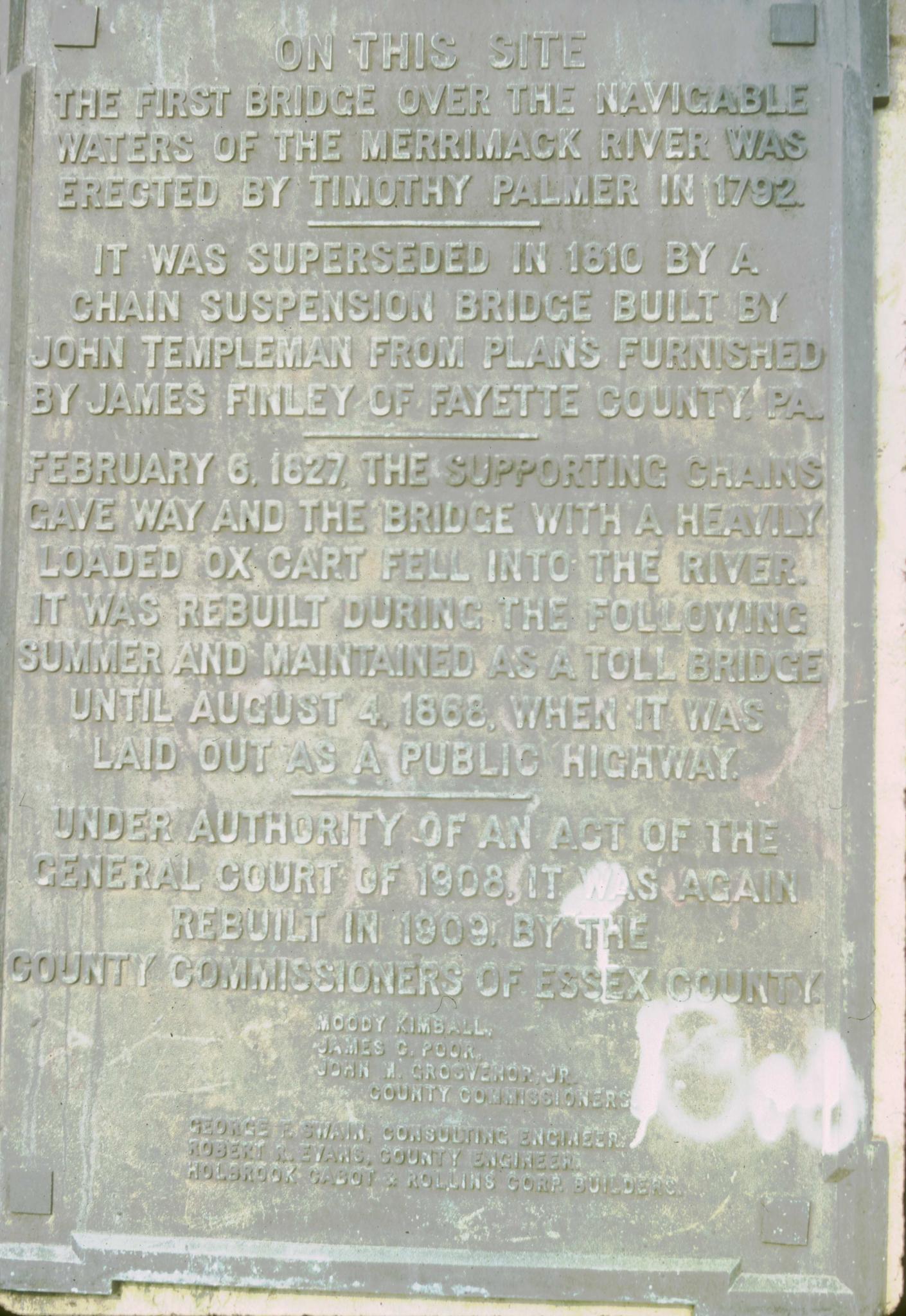 Photograph of a historical plaque giving the history of bridges at the site.