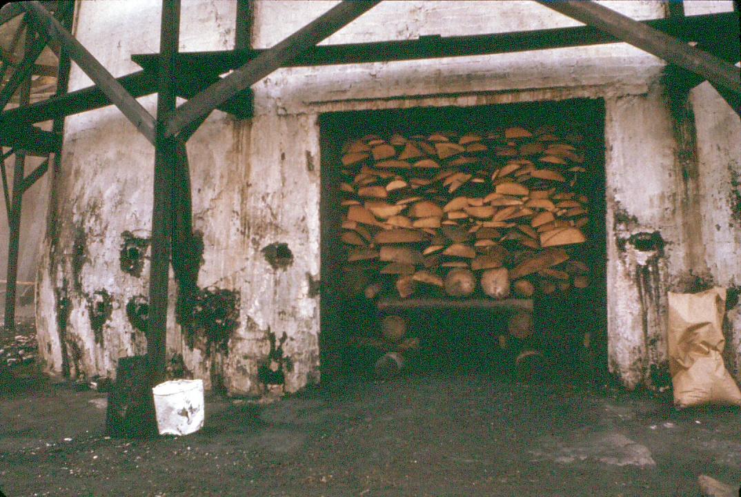 View of wood being prepared to burn in a charcoal kiln.