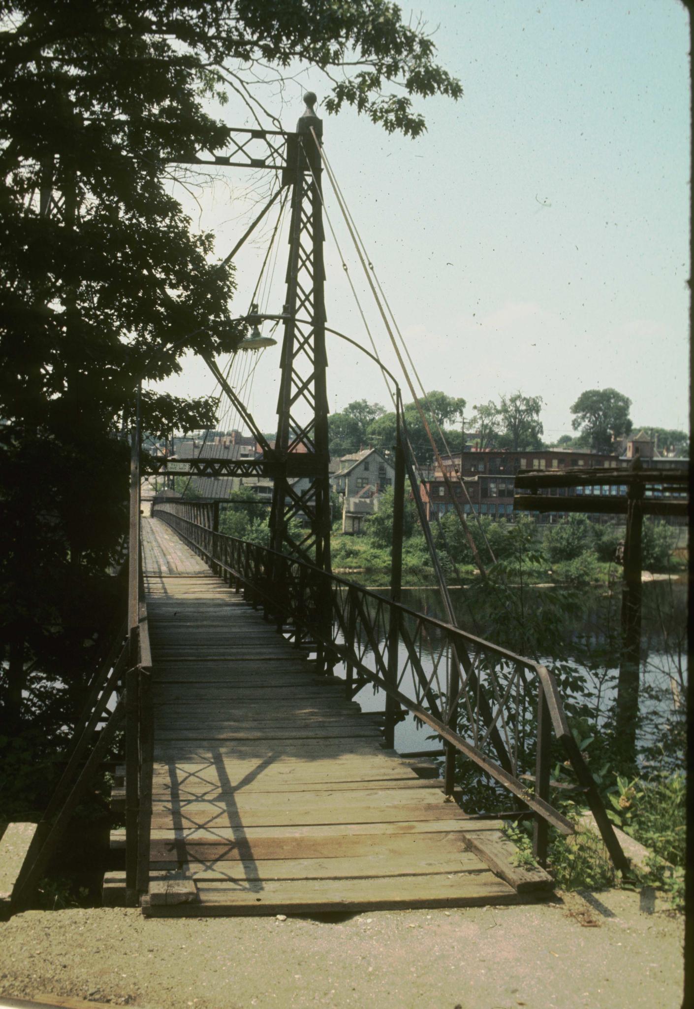 Photograph of the Ticonic foot bridge looking along the deck.  An abandoned…