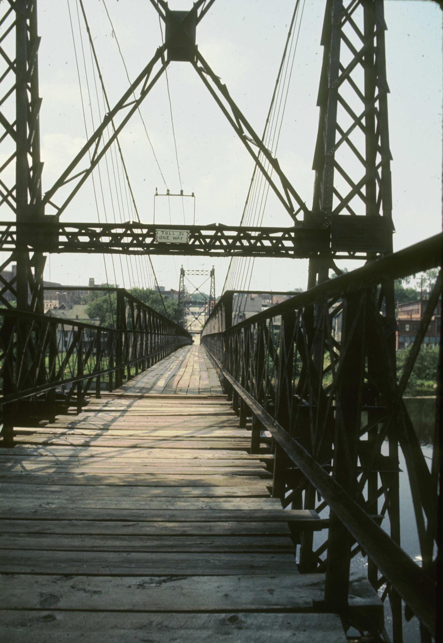 Photograph along the deck of the Ticonic foot bridge.