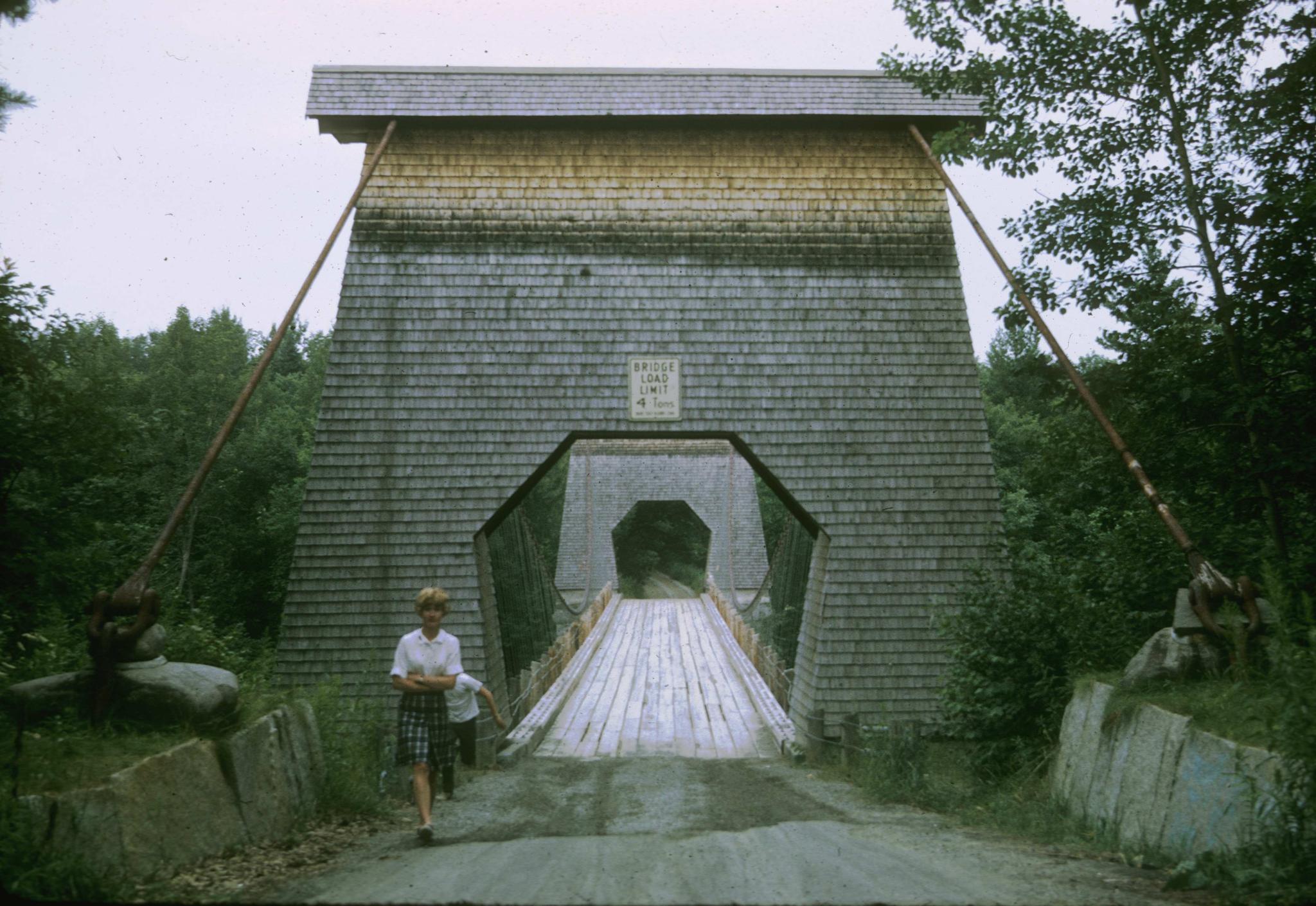 A photograph along the deck of the bridge detailing one of the wood-encased…