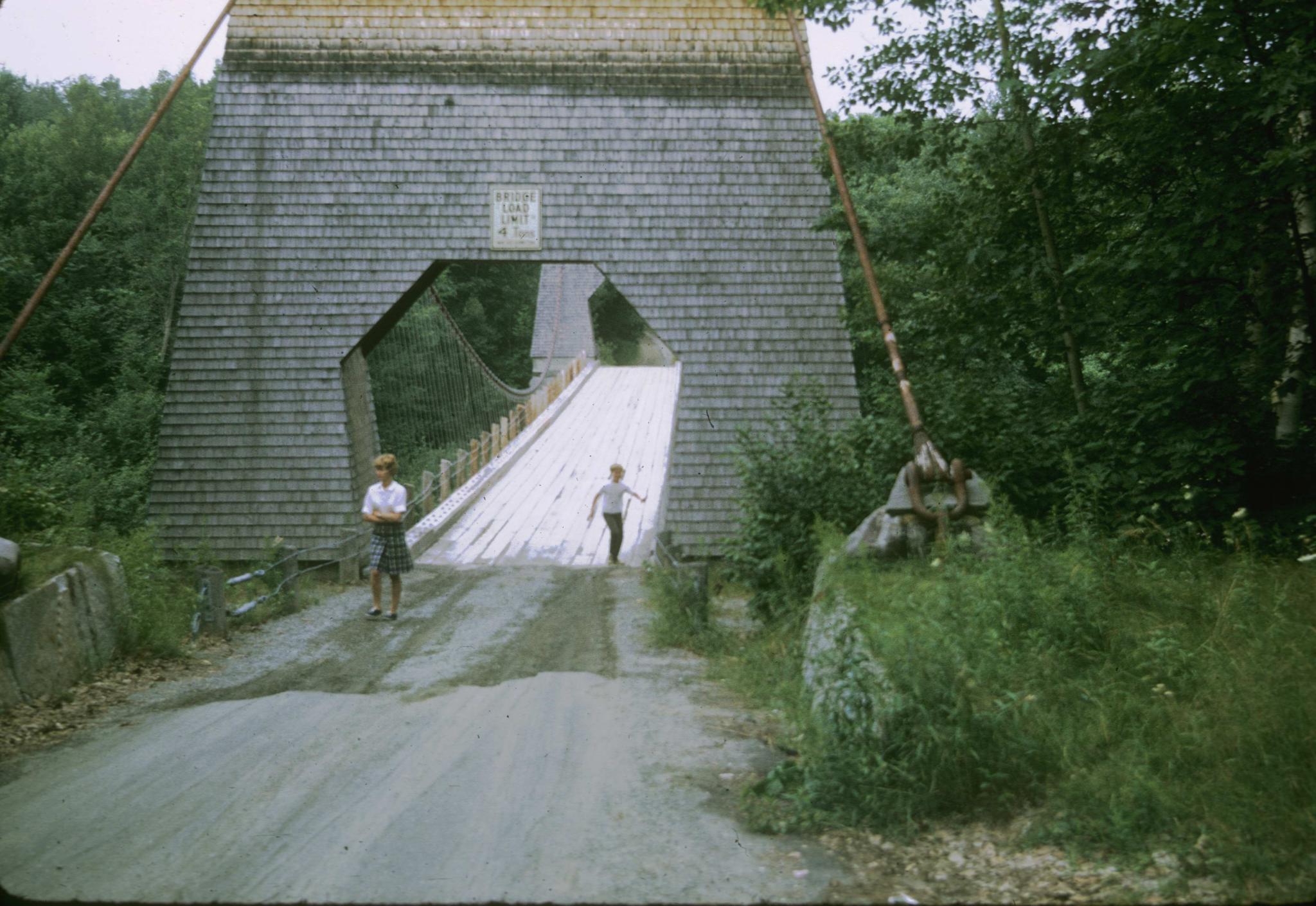 View down the deck of the bridge showing the enclosed tower and the anchor…