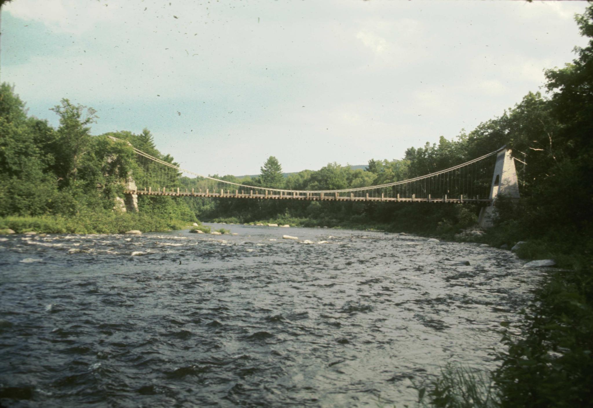 Side photograph of the bridge taken from the river.