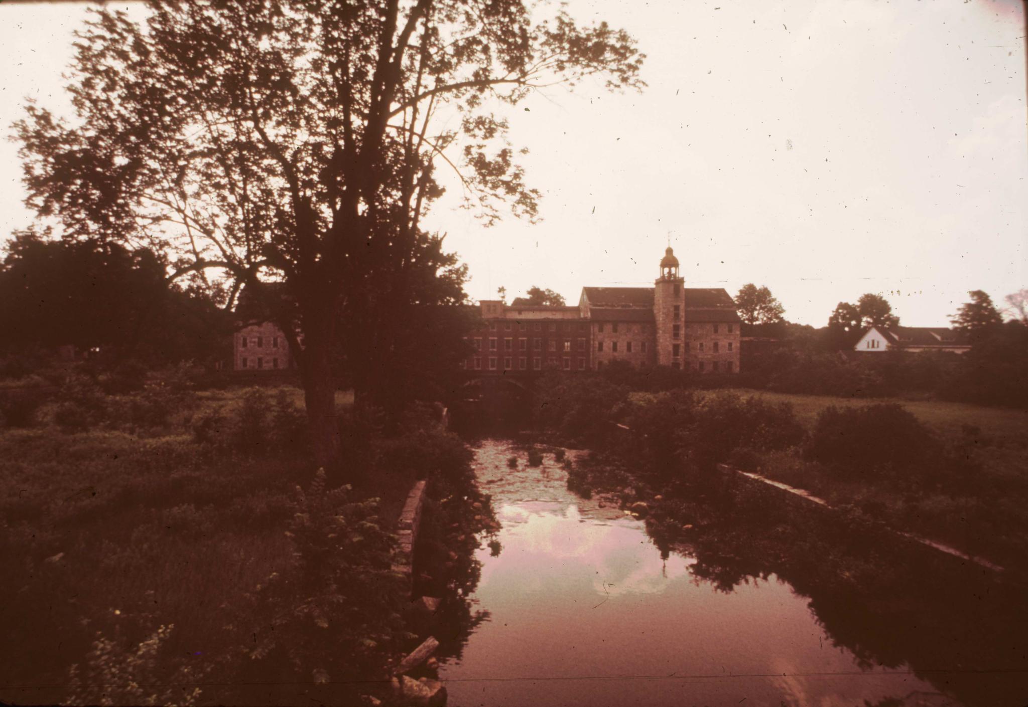 Photograph of the mill complex.  The slide is both dark and deteriorated (…