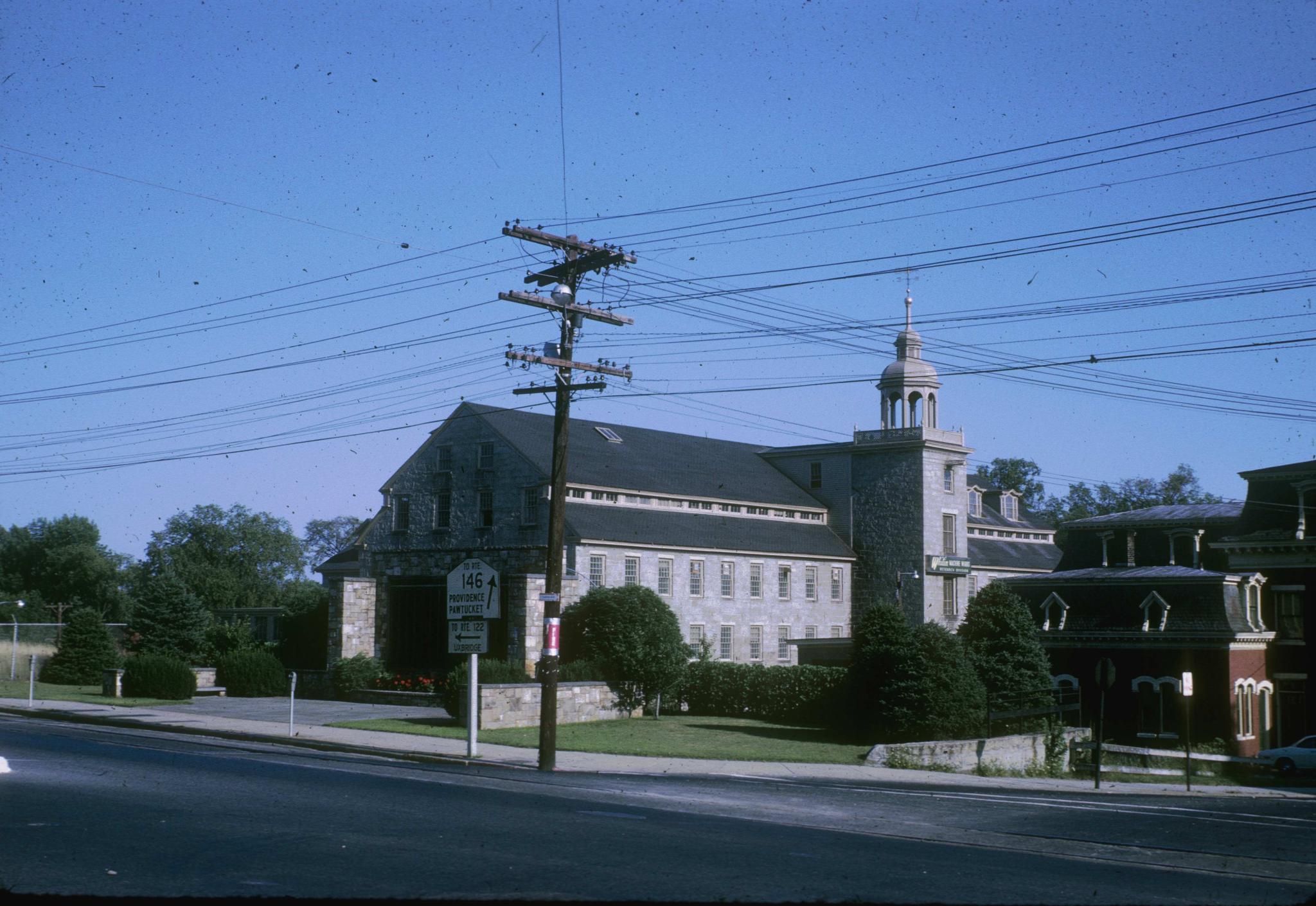 Photograph of the stone mill (The Shop) taken from the street.