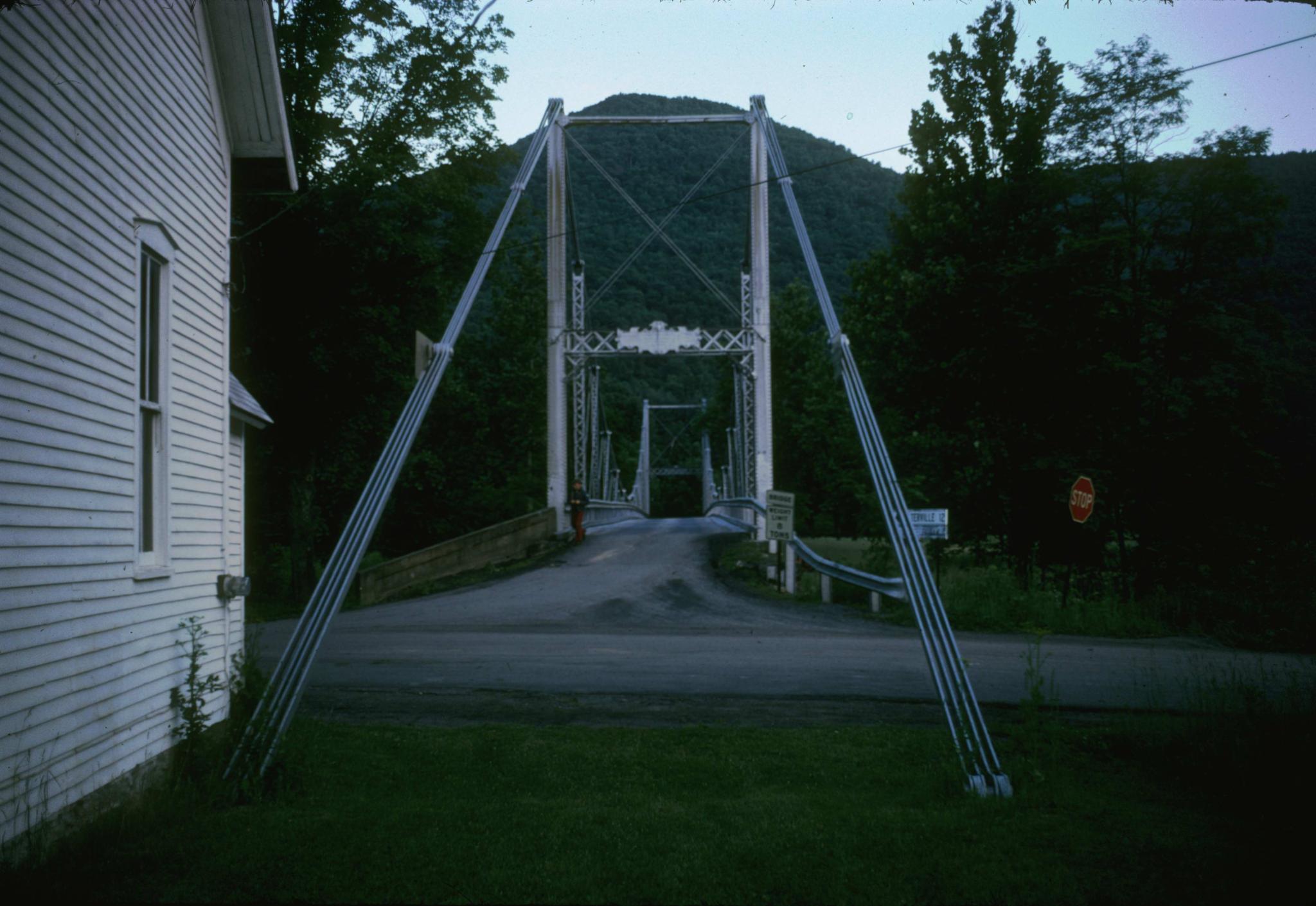 Photograph of the entry to the bridge showing the deck and where the eyebars…