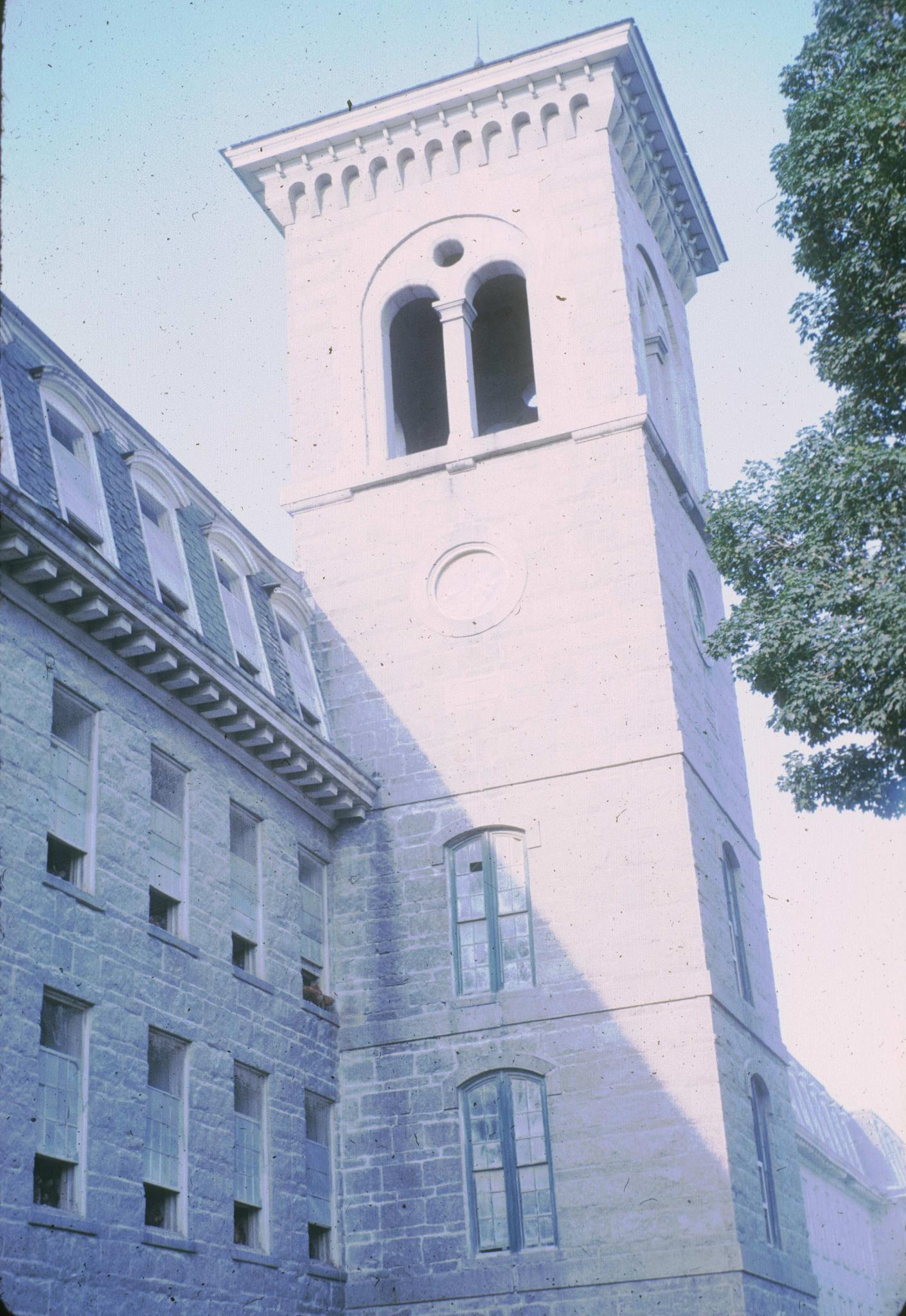 Photograph of the tower of the New Mill (1869).  The slide is over-exposed and…