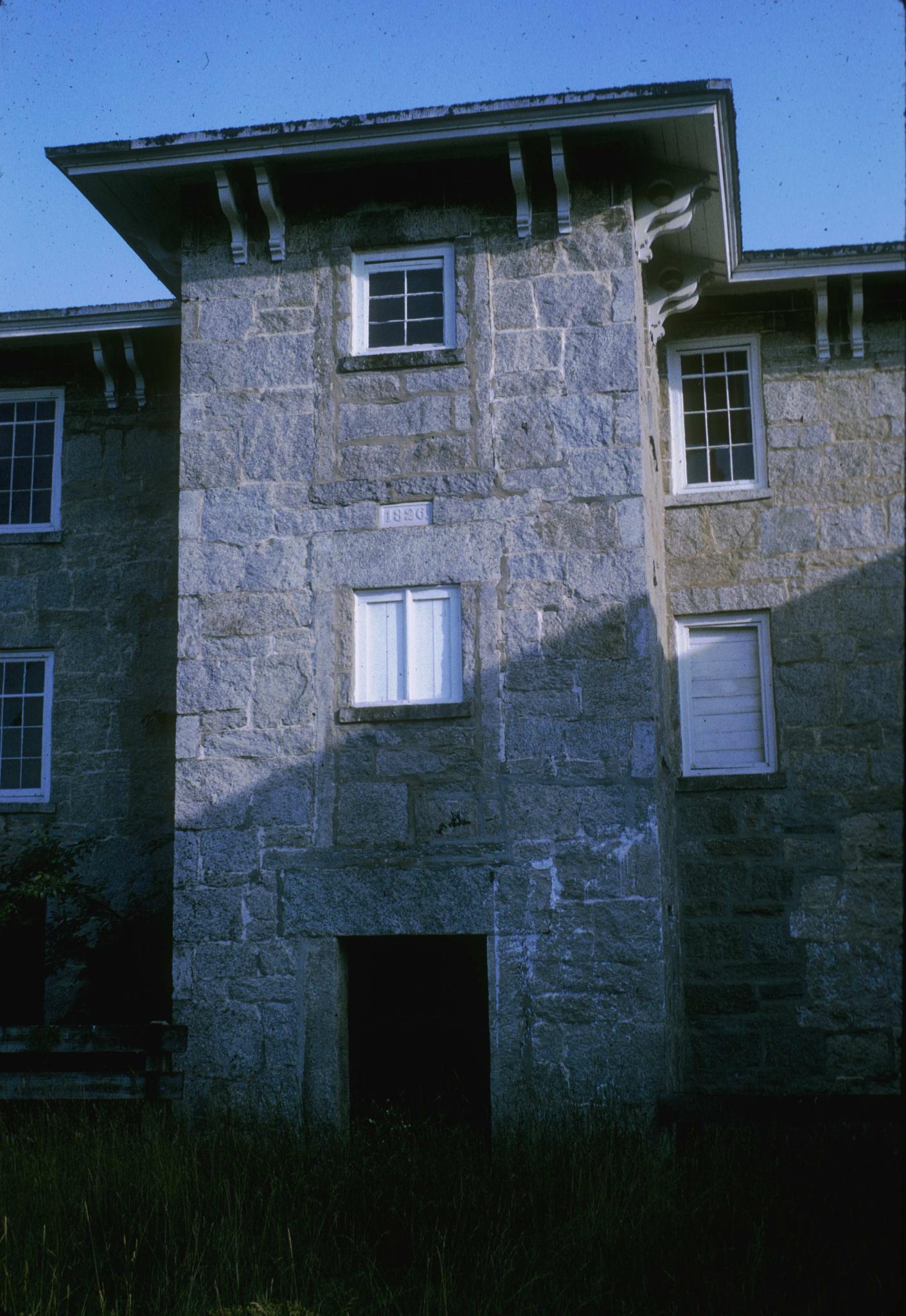 Photograph of the Old Mill (1826) showing the tower and the carved date.